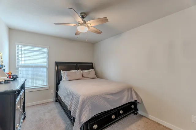 a bedroom with a bed and window