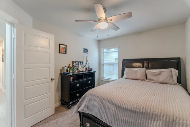a bedroom with a bed and a dresser