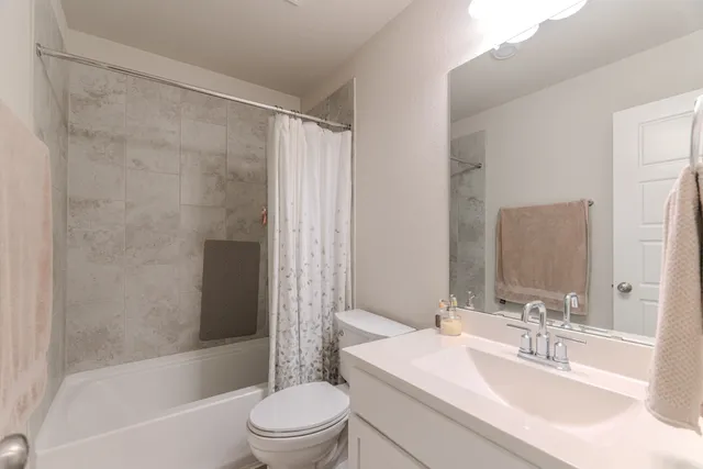 a bathroom with a sink mirror toilet and bathtub