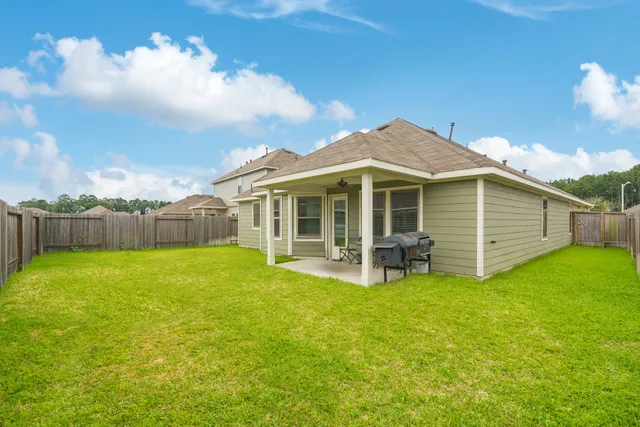 a view of a house with a yard and sitting area
