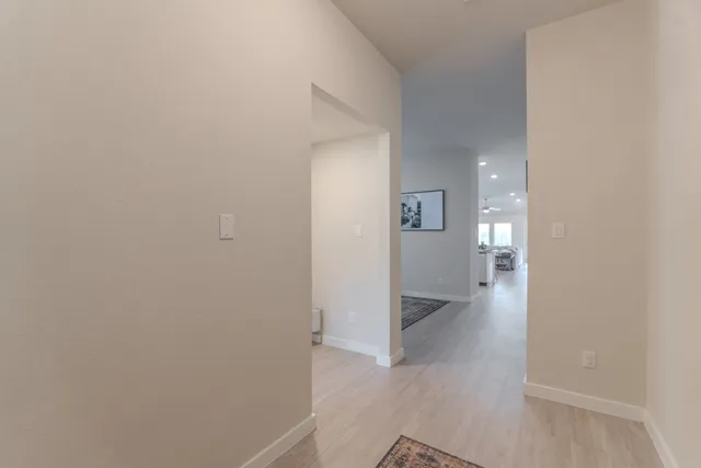 a view of a hallway with wooden floor