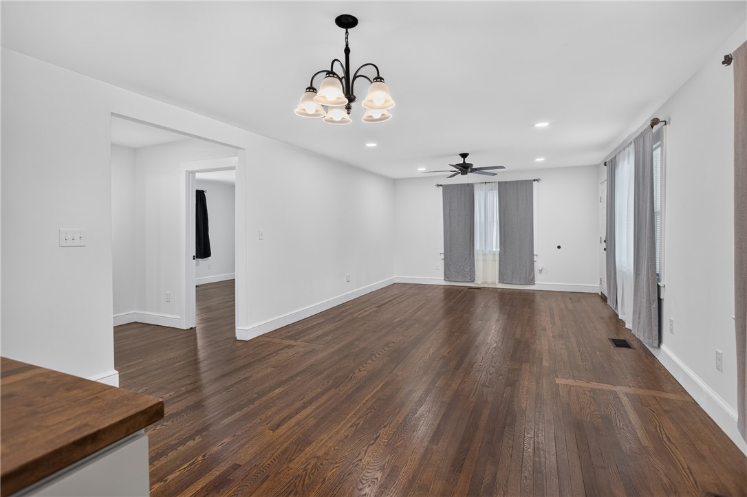 115 Pelfrey Street Seneca, SC 29672 - Photo 11 of 46 Rich hardwood flooring extends throughout this expansive living area, creating an inviting flow.
