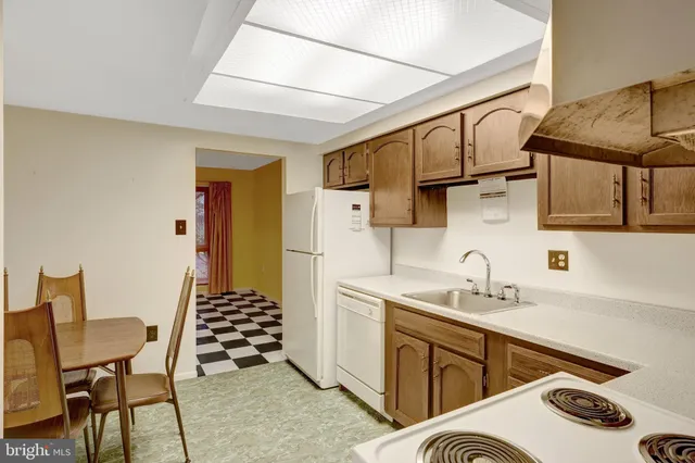 a kitchen with a sink appliances and cabinets