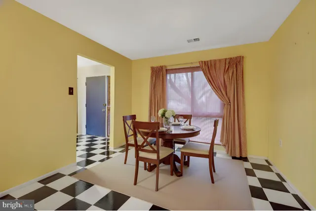 a dining room with furniture and wooden floor