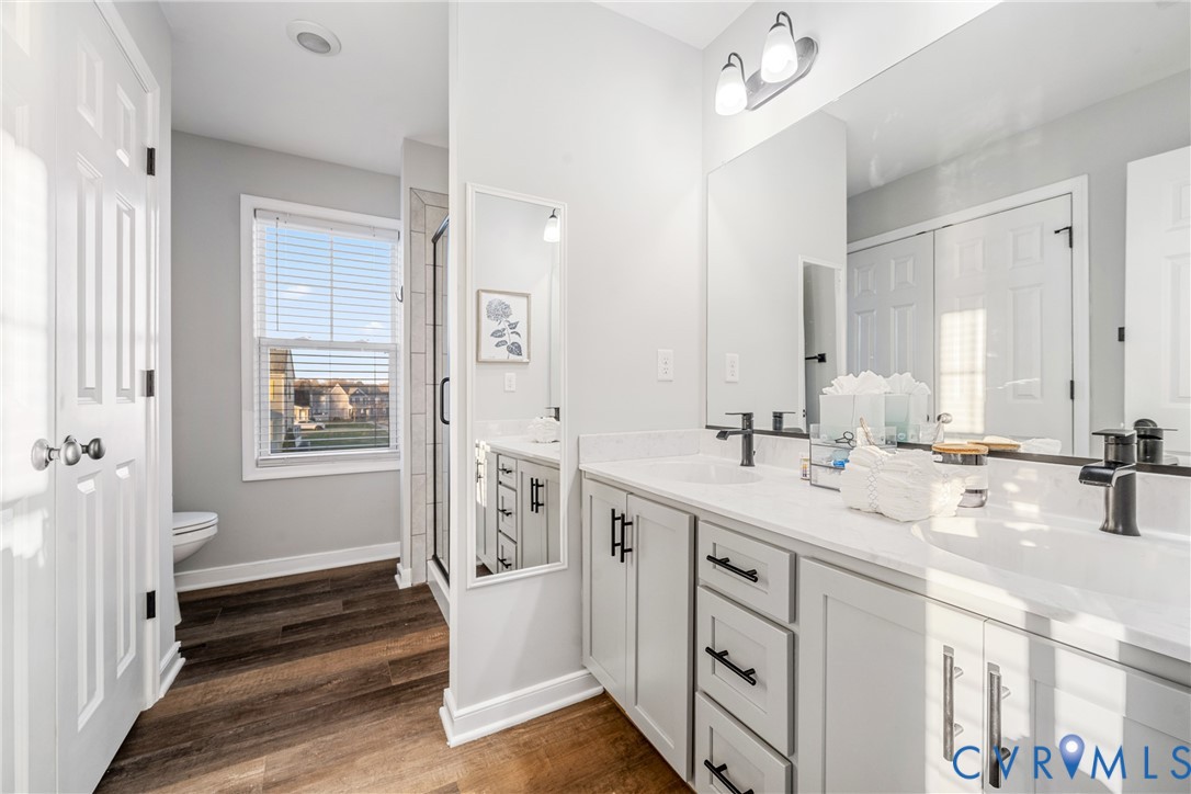 7401 Appelman Road Chesterfield, VA 23832 - Photo 10 of 17 a spacious bathroom with a double vanity sink a mirror a shower and a bathtub