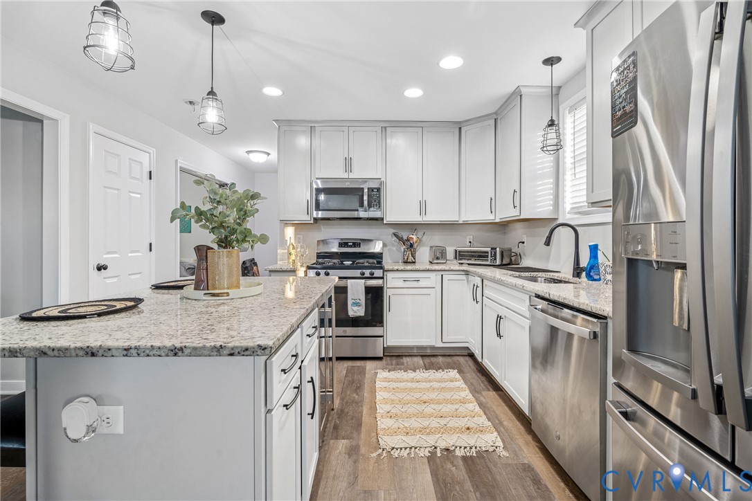 7401 Appelman Road Chesterfield, VA 23832 - Photo 5 of 17 a kitchen with stainless steel appliances granite countertop a sink a stove a refrigerator and cabinets
