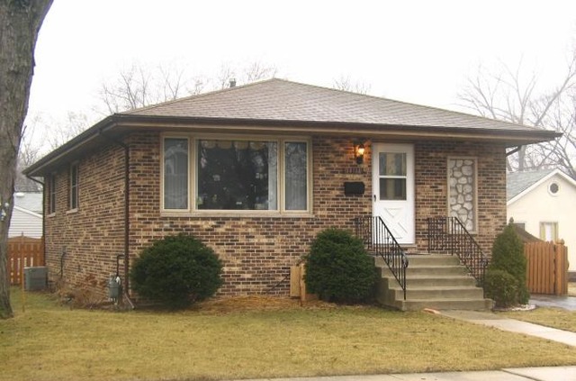 14514 Ridgeway Avenue Midlothian, IL 60445 - Photo 1 of 12 a front view of a house with a garden
