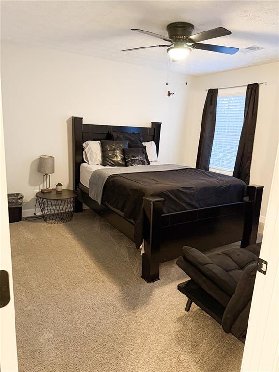 1264 GA Highway 211 Winder, GA 30680 - Photo 37 of 69 a bedroom with a bed and a chandelier