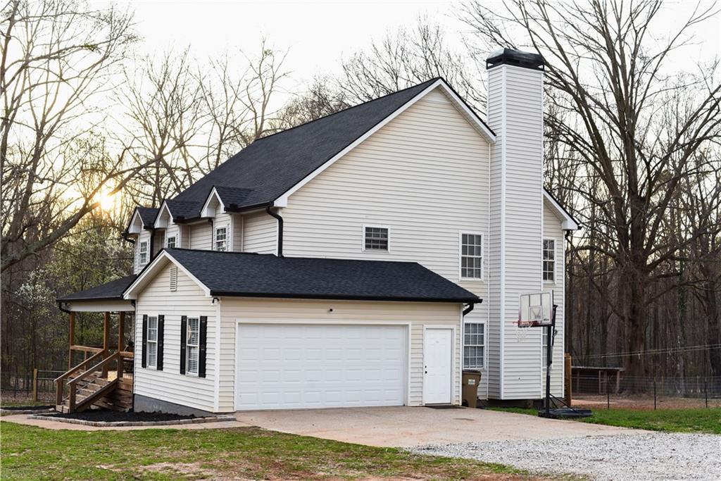 1264 GA Highway 211 Winder, GA 30680 - Photo 56 of 69 a view of a house with a big yard and large trees