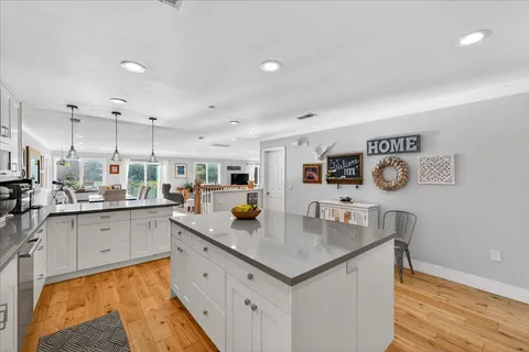 a kitchen with sink cabinets and wooden floor