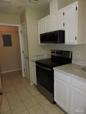 a kitchen with stainless steel appliances a stove a microwave and a refrigerator