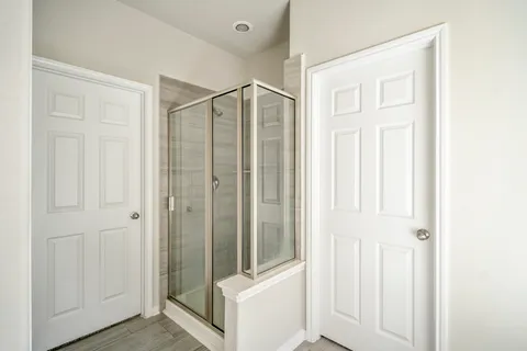 a view of a hallway with wooden floor and entryway