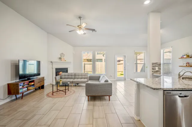 a living room with furniture and a flat screen tv