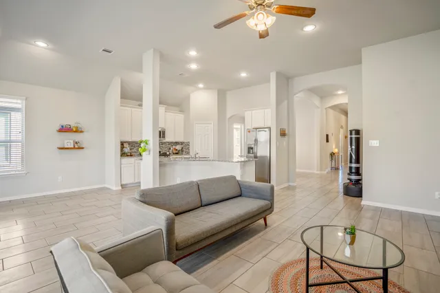 a living room with furniture and kitchen view