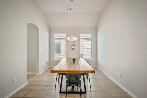 a very nice looking dining room with a table and chairs