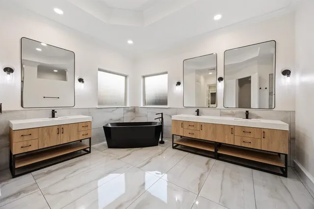 a large bathroom with a double vanity sink and a mirror