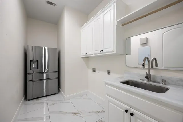 a kitchen with a sink and refrigerator