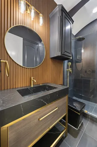 a kitchen with kitchen island granite countertop a sink a stove and a refrigerator