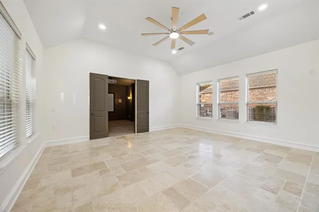 an empty room with windows and closet