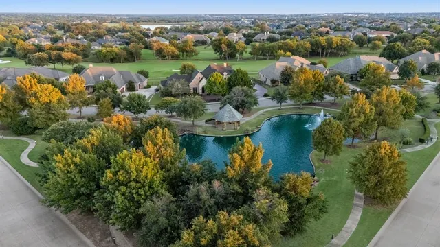 an aerial view of lake residential houses with outdoor space and swimming pool