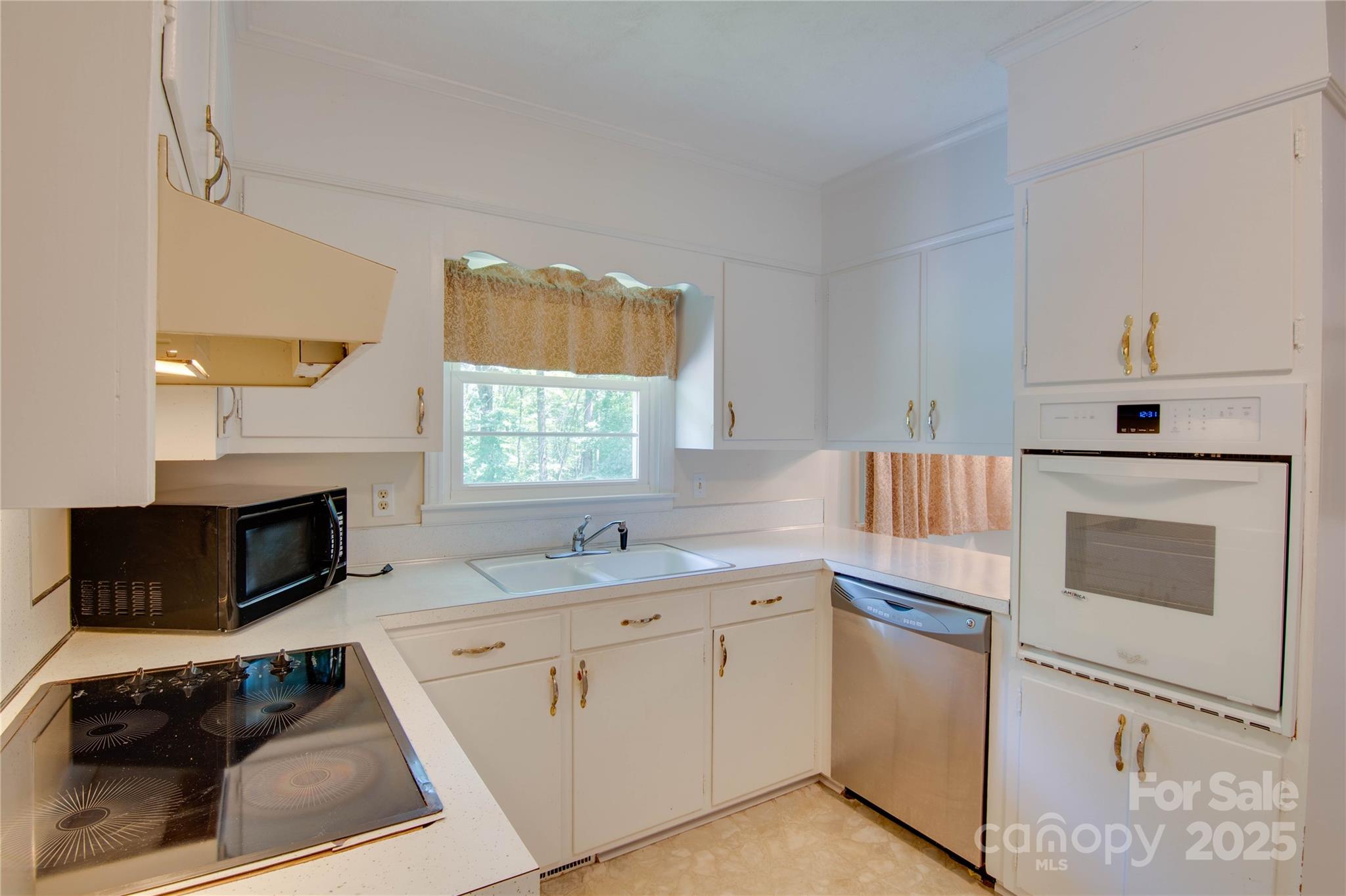 2319 Tin Mine Road Lincolnton, NC 28092 - Photo 12 of 30 a kitchen with white cabinets sink and white appliances