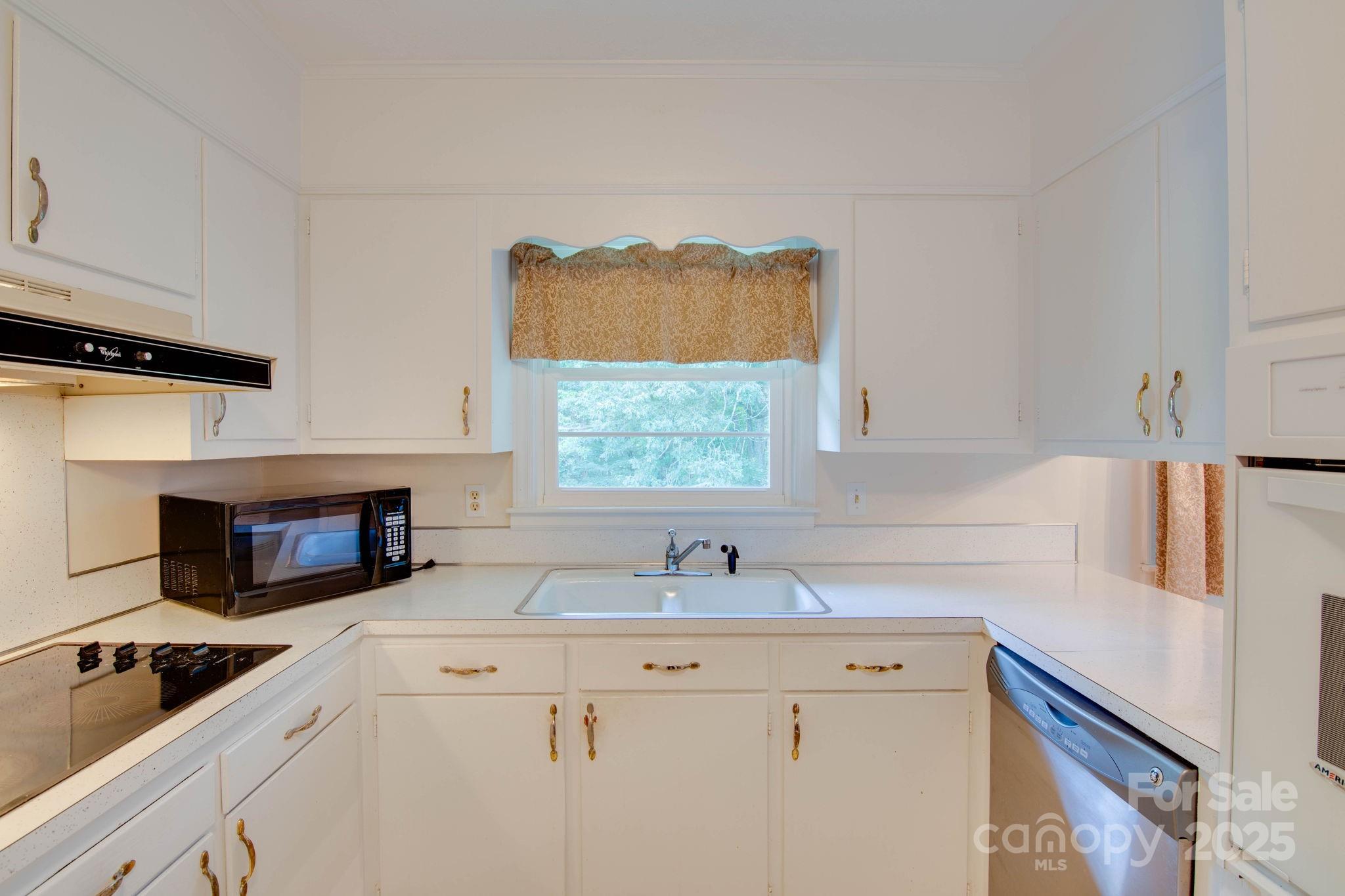 2319 Tin Mine Road Lincolnton, NC 28092 - Photo 14 of 30 a kitchen with stainless steel appliances a sink stove and a window