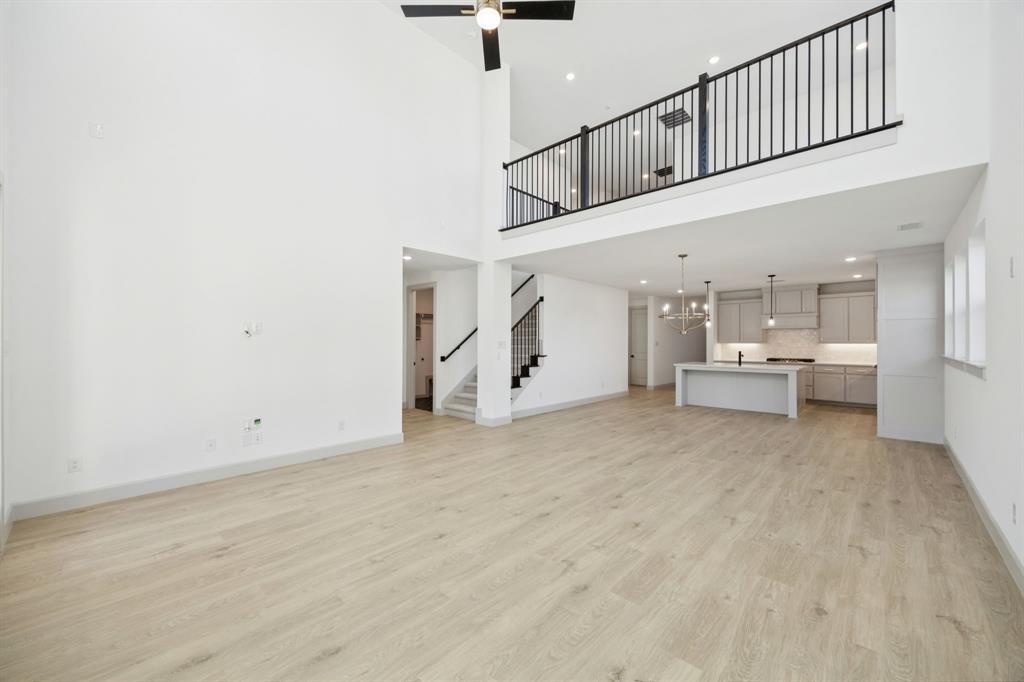 1400 Rose Mallow Road Celina, TX 75009 - Photo 9 of 21 Our Versailles III plan features a game room with open railing that overlooks the family room below creating a multi-level entertainment area!