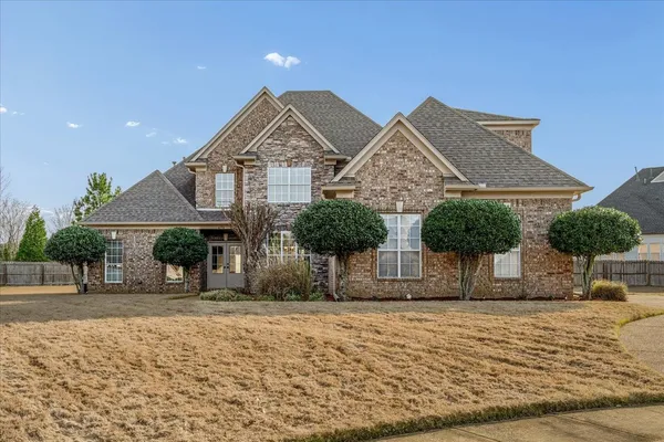 a front view of a house with a yard