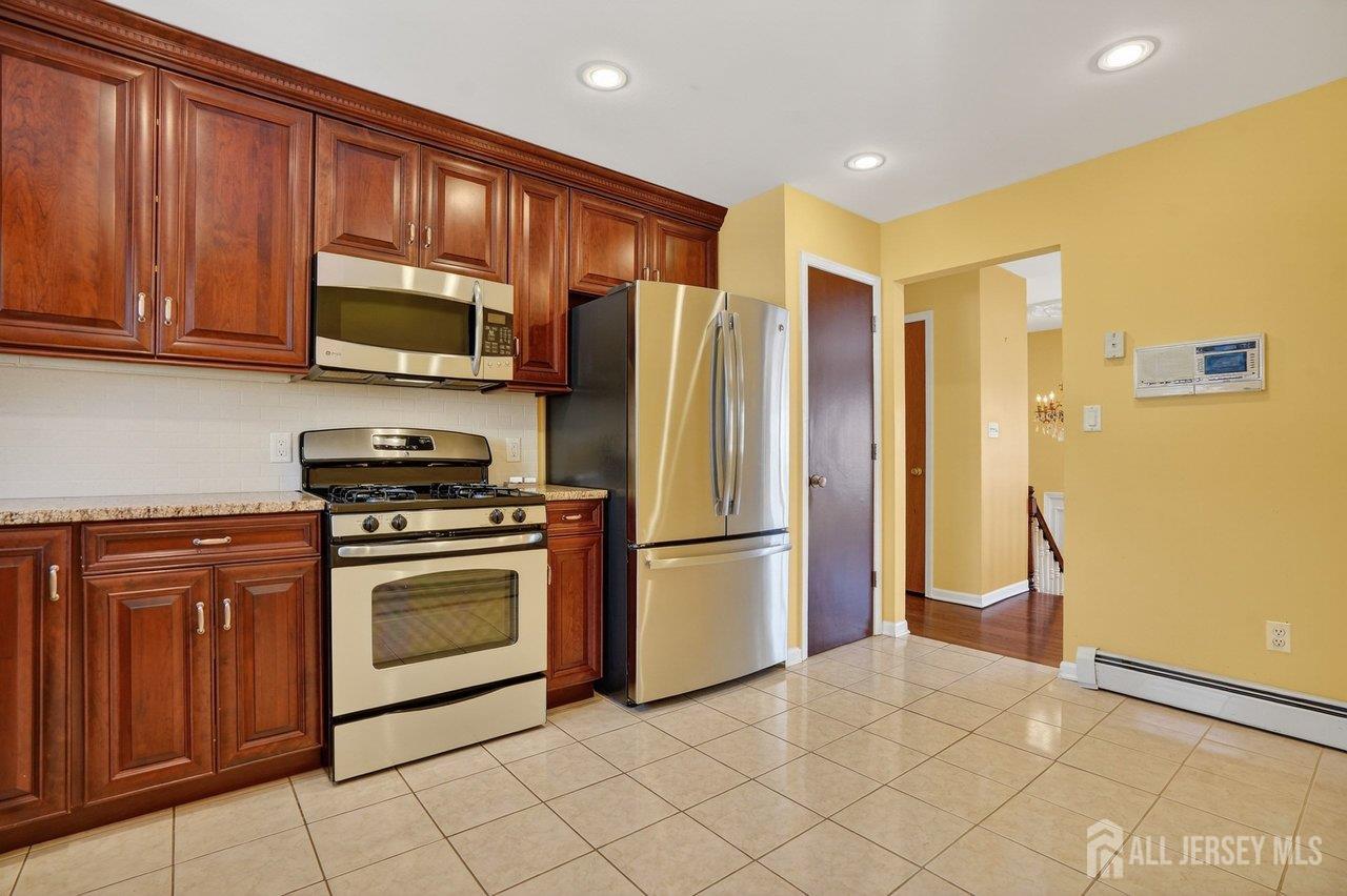 1 Wakefield Drive Edison, NJ 08820 - Photo 8 of 29 a kitchen with stainless steel appliances granite countertop a refrigerator stove and sink