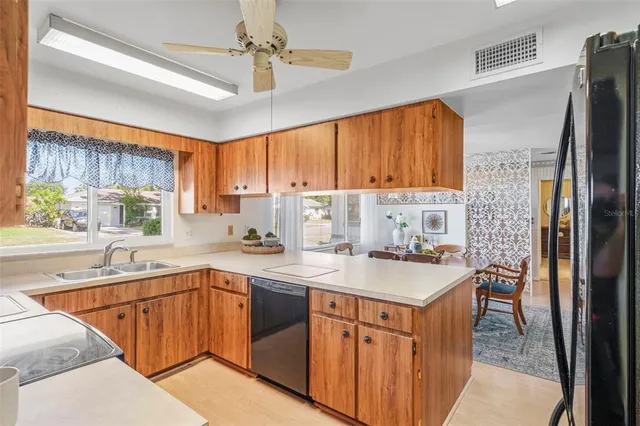 a kitchen with a refrigerator a stove a sink dishwasher and a microwave oven