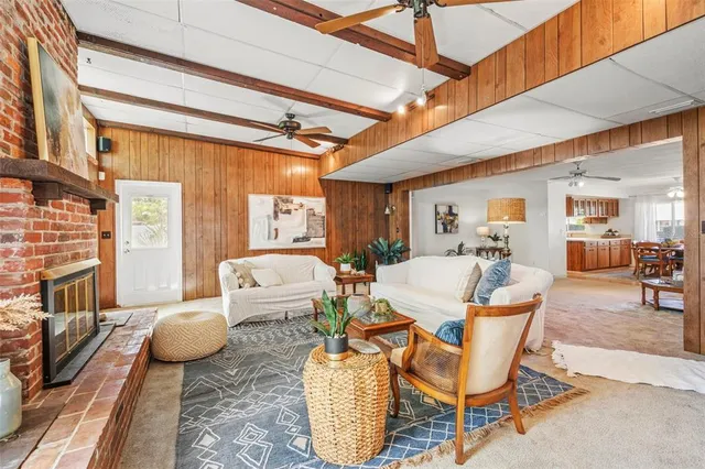 a living room with furniture a fireplace and a table