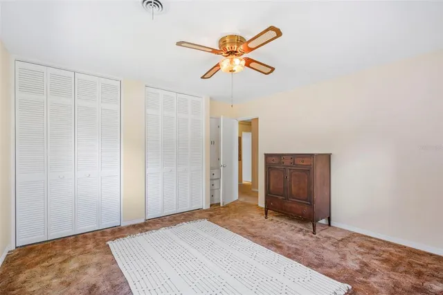 a bedroom with two beds and a chandelier