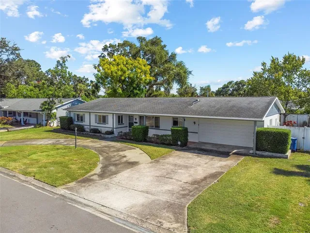 a view of a house with swimming pool and a yard