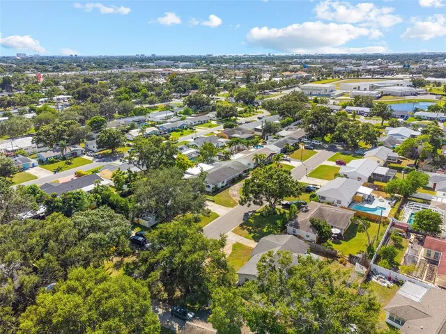 an aerial view of residential houses with outdoor space and parking