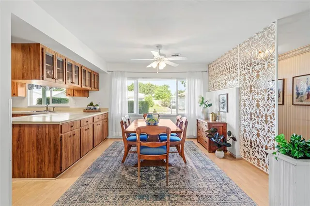 a living room with furniture a table and kitchen view