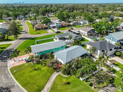 an aerial view of a house with a garden and lake view