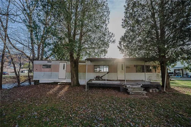 a wooden bench sitting in front of a house