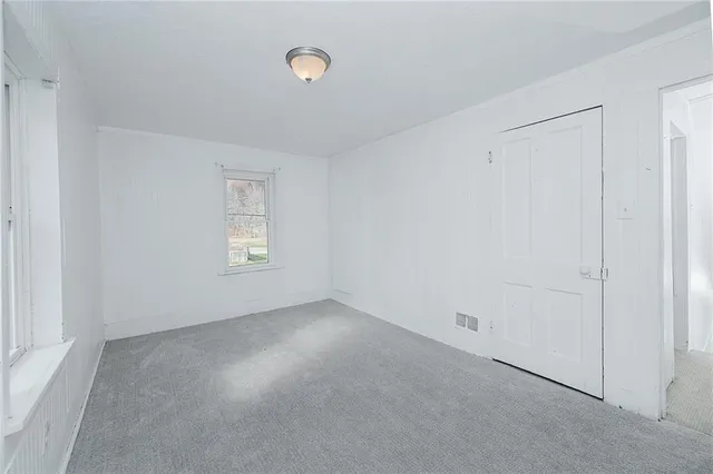 an empty room with a empty space and windows