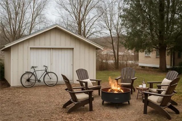 a backyard of a house with table and chairs
