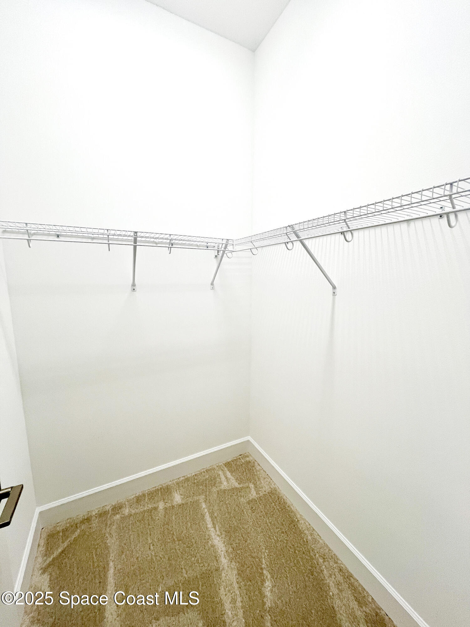 7707 Cache Crk Lane Melbourne, FL 32940 - Photo 10 of 18 a view of small space with racks on the wall