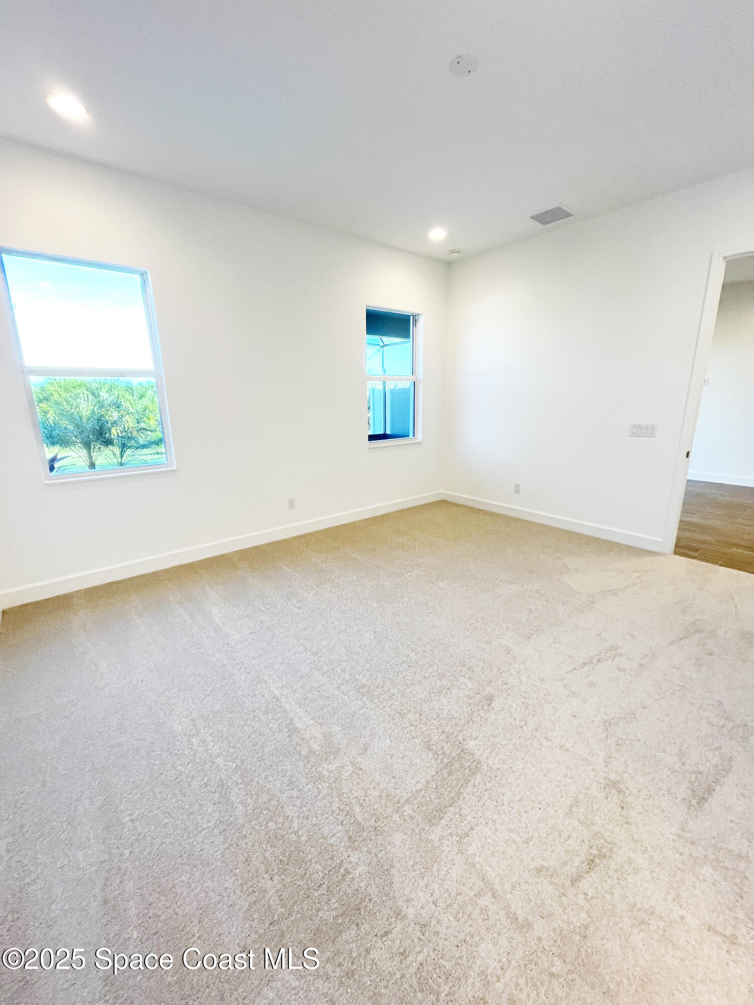 7707 Cache Crk Lane Melbourne, FL 32940 - Photo 11 of 18 an empty room with windows