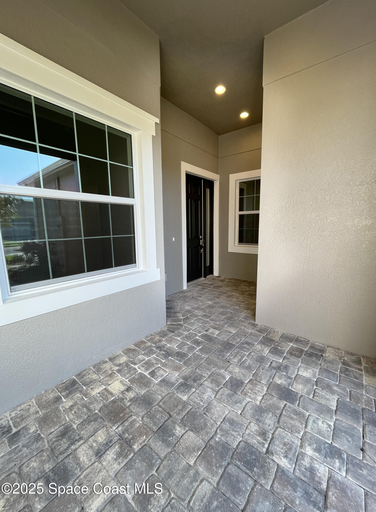 7707 Cache Crk Lane Melbourne, FL 32940 - Photo 3 of 18 a view of empty room with windows