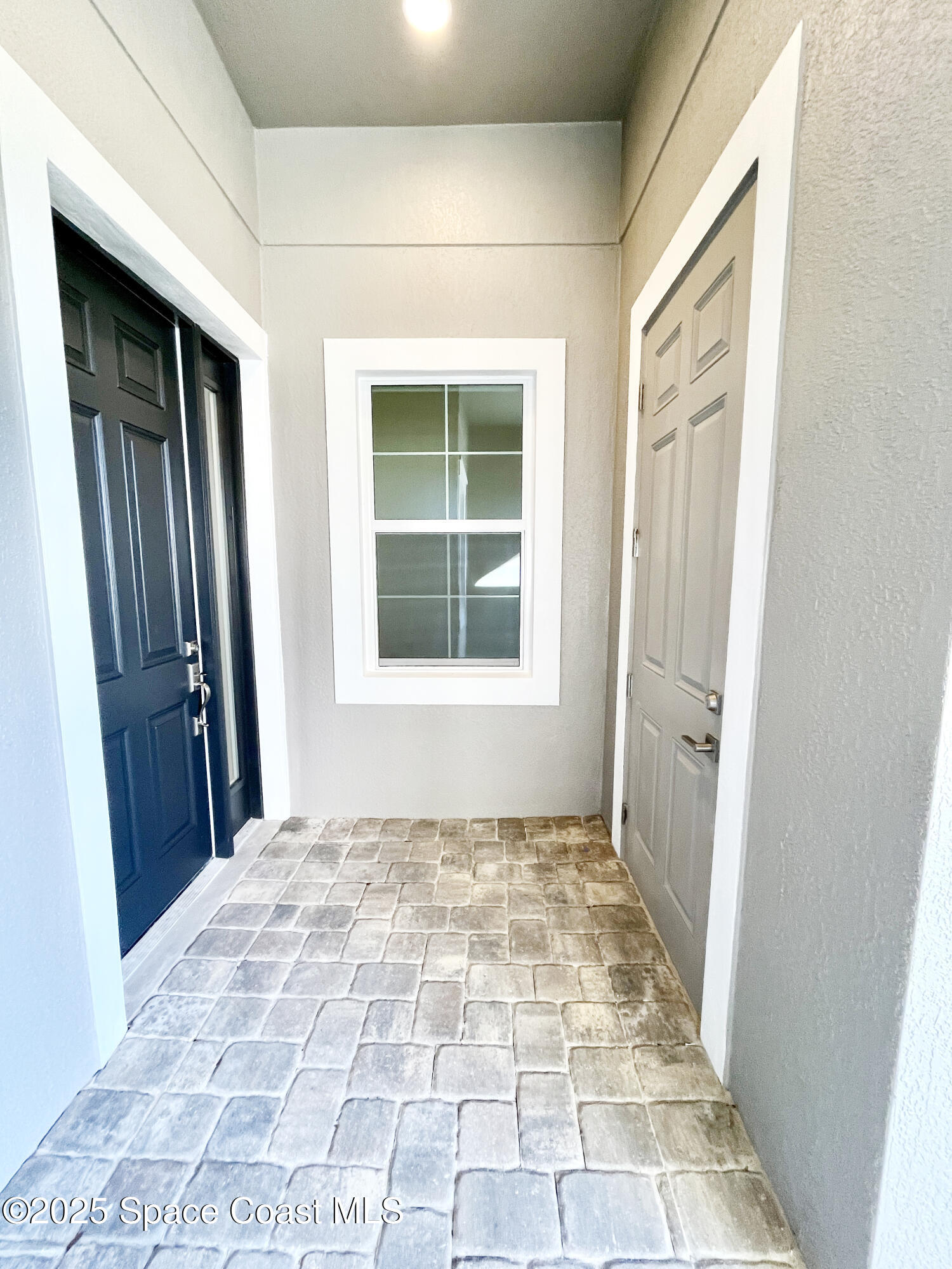 7707 Cache Crk Lane Melbourne, FL 32940 - Photo 4 of 18 a view of an empty room with a window