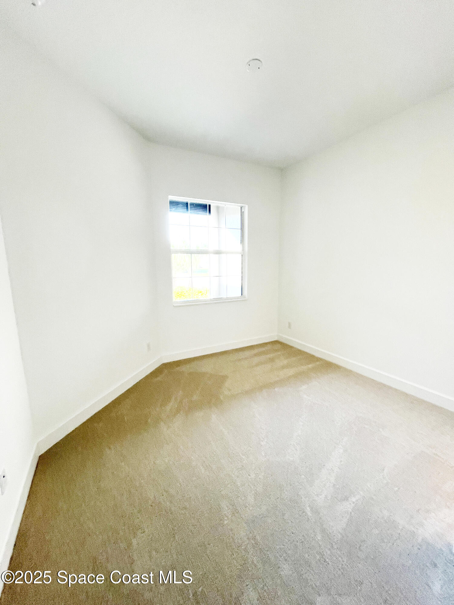 7707 Cache Crk Lane Melbourne, FL 32940 - Photo 7 of 18 an empty room with a window