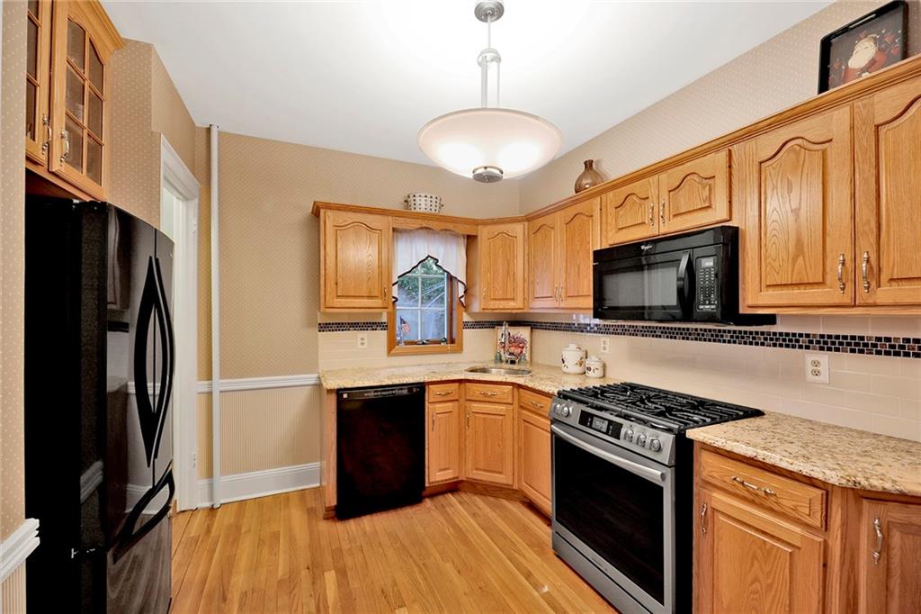 7607 Colonial Road Brooklyn, NY 11209 - Photo 6 of 35 a kitchen with stainless steel appliances granite countertop a stove top oven a sink dishwasher a refrigerator and a microwave