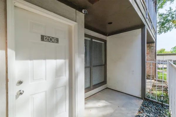 a hallway with sliding door and front door