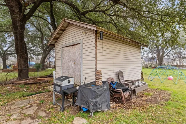 a view of a chairs and table in backyard of the house