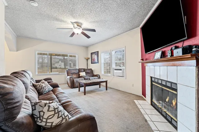 a living room with furniture a flat screen tv and a fireplace