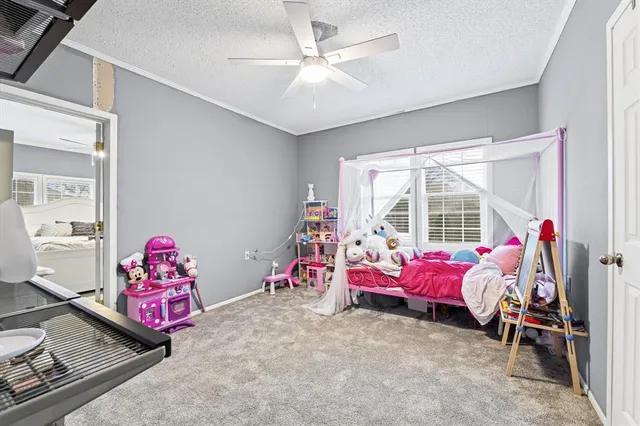 a bedroom with furniture and a large window