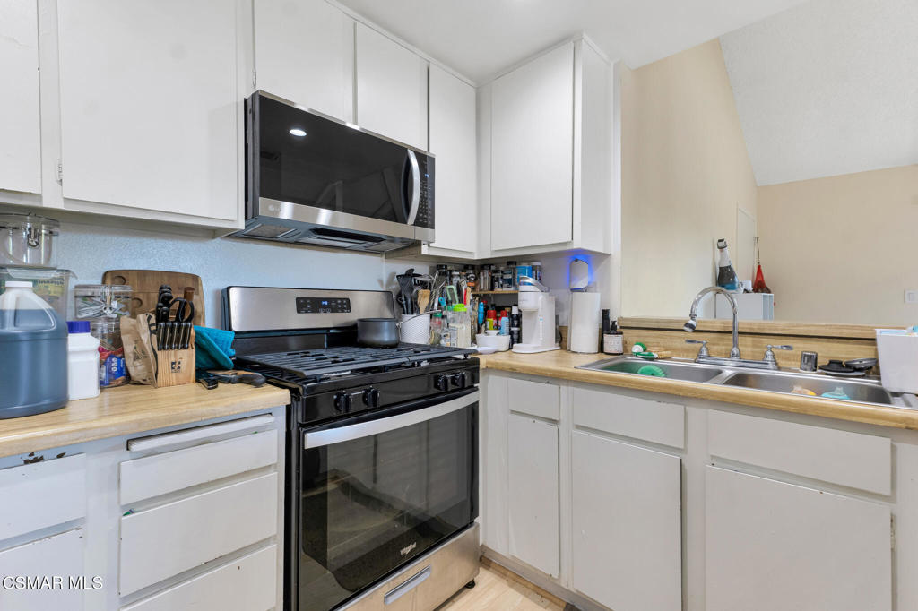 1932 Heywood Street, Unit B Simi Valley, CA 93065 - Photo 19 of 28 a kitchen with stainless steel appliances granite countertop a sink and a stove